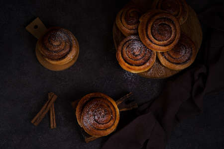 Homemade buns with cinnamon and powdered sugar, homemade pastries, top viewの写真素材