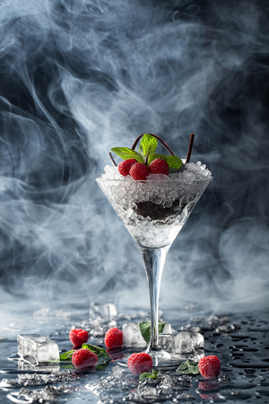 Creative fruit platter: raspberries and chocolate. Elegant dessert in the smoke ambiance.の写真素材