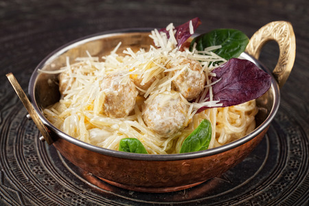 Pasta with meatballs. Elegant pasta dish served in the copper bowl.の写真素材