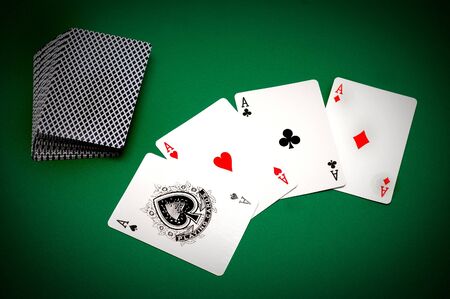 Cards and poker chips on a green background