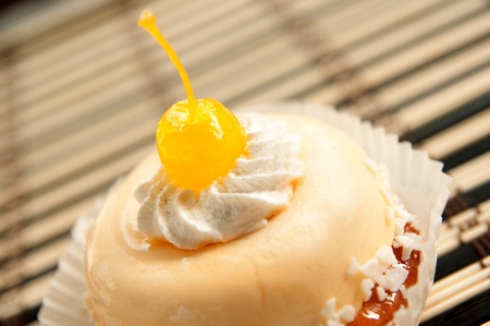 White cake and icing desert with a cherry on top.の写真素材