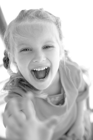 cute little girl smiling in a park close-upの写真素材