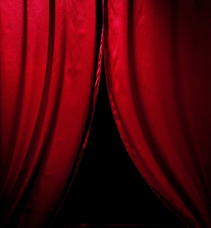 red theater curtain with soft lighting over blackの写真素材