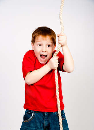 little boy with a rope in his handsの写真素材