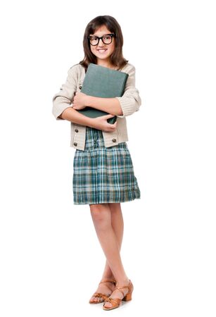 Little girl with a book in glasses on a white backgroundの写真素材