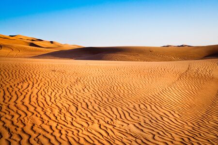 sandy desert on background of blue skyの写真素材