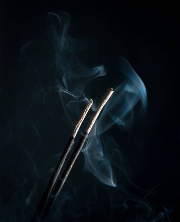 incense with smoke on black backgroundの写真素材
