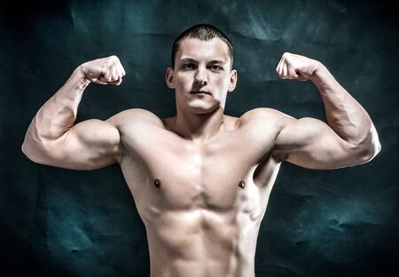 Handsome muscular man on dark backgroundの写真素材