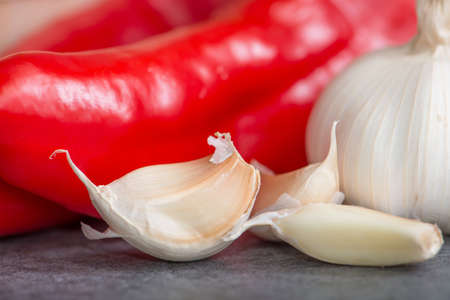 garlic with fresh colorful vegetables on tableの写真素材