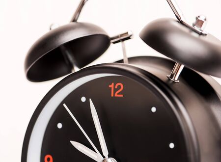 black alarm clock on light backgroundの写真素材