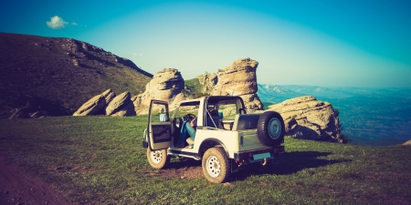 car in beautiful mountains in retro colorsの写真素材