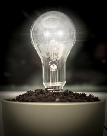 A light bulb in pot with soilの写真素材