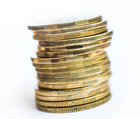 stack of gold coins isolated on a white backgroundの写真素材
