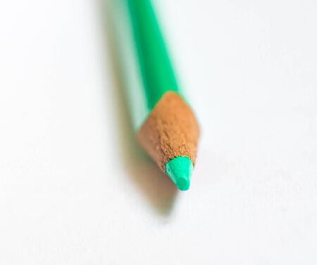 green pencil on white paperの写真素材