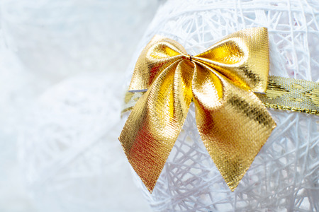 Gold Christmas bow on white Christmas Bellの写真素材