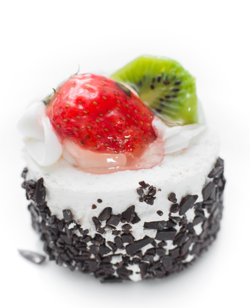 cake with strawberries and kiwi photographed close on a white backgroundの写真素材