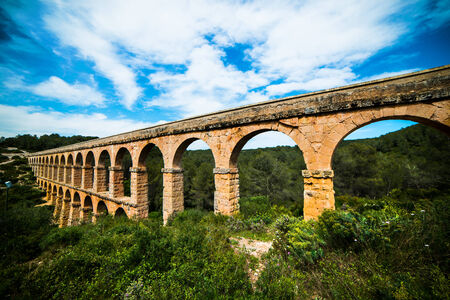 Old Stone Arch bridge in Spain near Barcelonaの写真素材