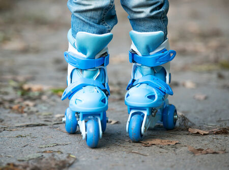 little girl on blue roller skates