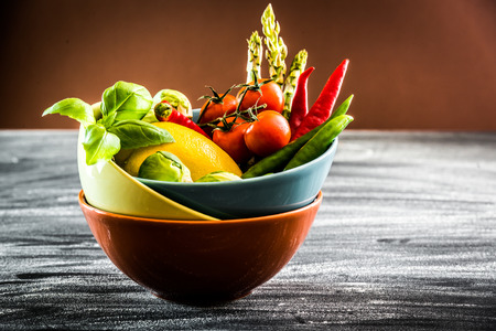 Fresh vegetables in a bowl on the tableの写真素材
