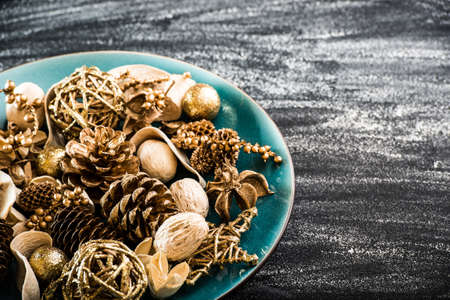 plate with a Christmas tree toys on a black textured background