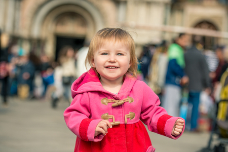 cute little girl walking on the Piazza San Marco in Venice, Italyの写真素材