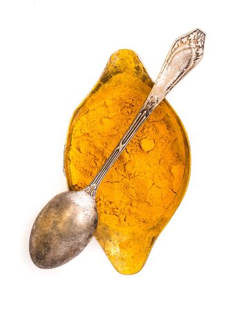 dry curry in a saucepan with a spoon isolated on a white backgroundの写真素材