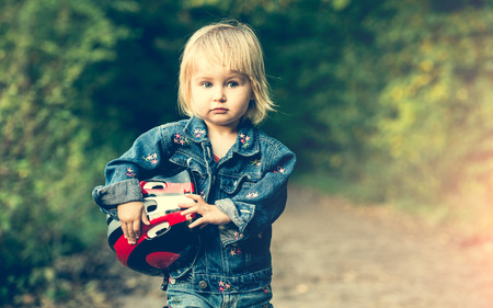little girl on roller skates with helmet in the parkの写真素材