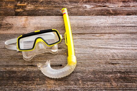 Diving stuff. Mask and snorkel diving on a wooden backgroundの写真素材