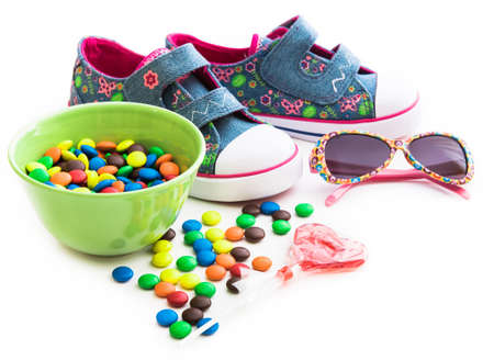 colorful childrens stuff and sweets on a white backgroundの写真素材