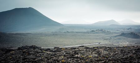 beautiful landscape with mountain road in Timanfaya National Park in Lanzarote, Canary Islandsの写真素材