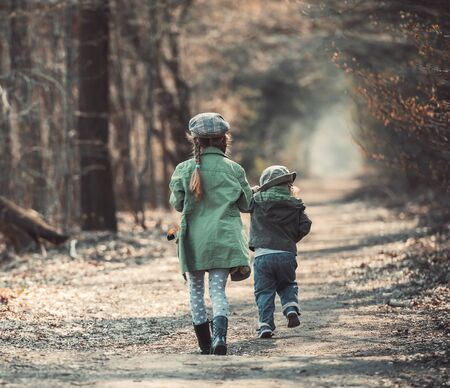 small children play in the woods, photo in vintage styleの写真素材