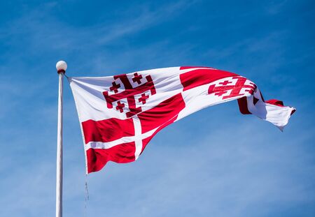 photo of maltese flag in the sky in Vallettaの写真素材