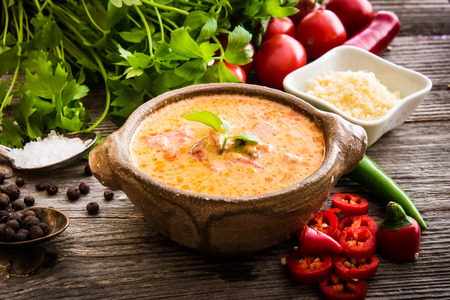 Sope queso with vegetables and spices on a wooden backgroundの写真素材