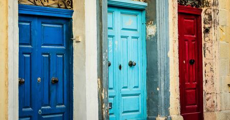three doors of different color in a street of Valletta in Maltaの写真素材
