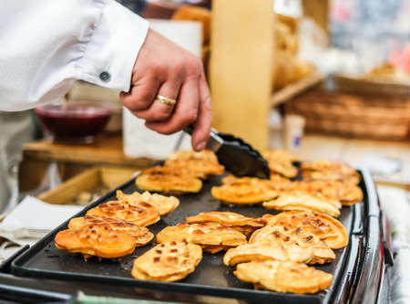 frying bakery on a sheet at outside cooking fairの写真素材