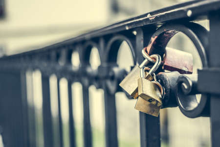 macro photo of two locks on a bridgeの写真素材