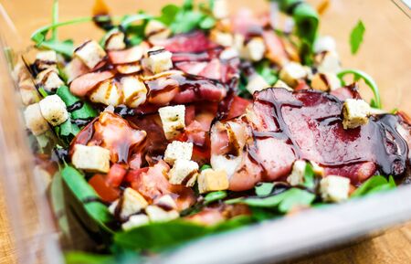 salad with vegetables, bacon and crackers and fork macro photoの写真素材