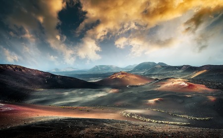 beautiful mountain landscape with volcanoes at sunset in Timanfaya National Park in Lanzarote, Canary Islandsの写真素材