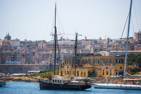 ship in the Valletta port in Malta on the background of the cityの写真素材