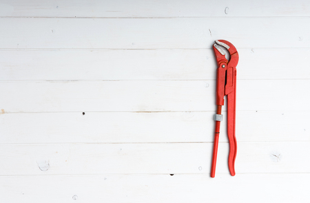 red adjustable wrench with text space on white wooden backgroundの写真素材