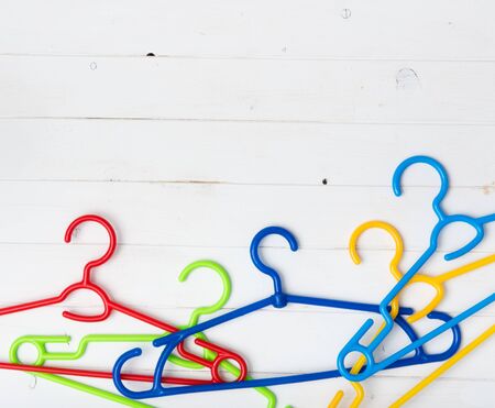 set of colorful plastic clothes hangers with text spaceの写真素材