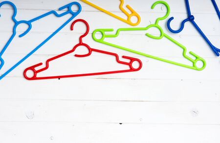 set of colorful plastic clothes hangers with text spaceの写真素材