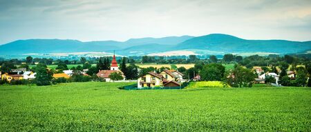 picturesque panorama of colorful countryside landscape with mountains on the backgroundの写真素材