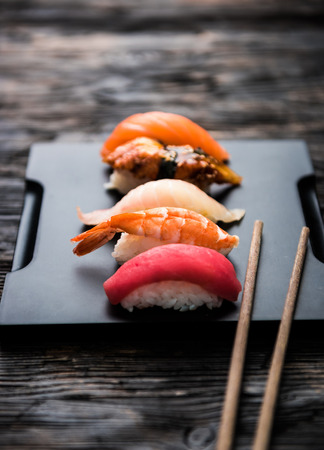 sashimi sushi set with chopsticks and soy on black backgroundの写真素材