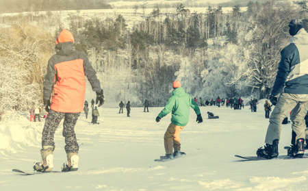 people on snowboards on snowhillの写真素材