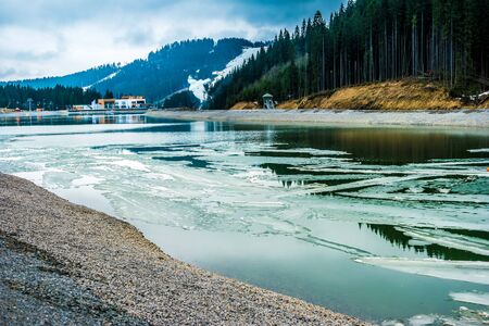 beautiful montain landscape with lake and floating ice in Carpathian mountains, Ukraineの写真素材