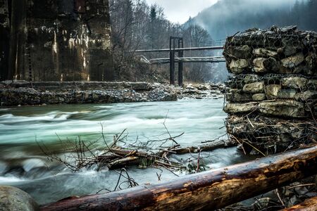 beautiful mountain landscape with lake and bridges in fog in Ukrainian Carpathiansの写真素材