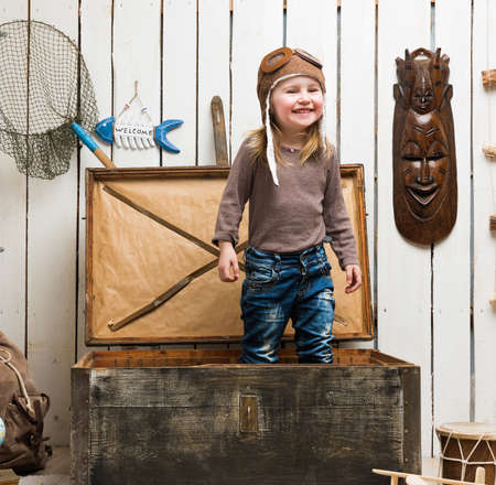 funny little girl-pilot in old wooden chest