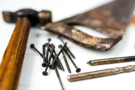 different carpenters and mechanics tools on a white wooden table