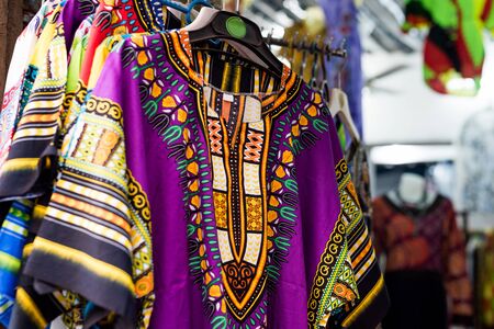 beautiful colorful traditional clothes with patterns at african marketの写真素材